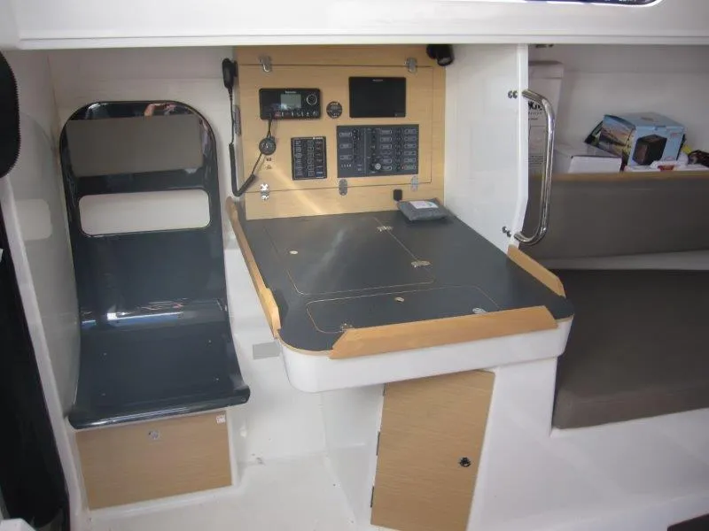 Slide: The Image of Navigation station of 2018 Jeanneau Sun Fast 3600 yacht, featuring control panels and seating. - 14