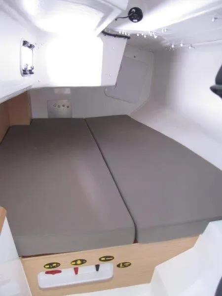 Slide: The Image of 2018 Jeanneau Sun Fast 3600 cabin interior with gray cushions and white walls. - 16