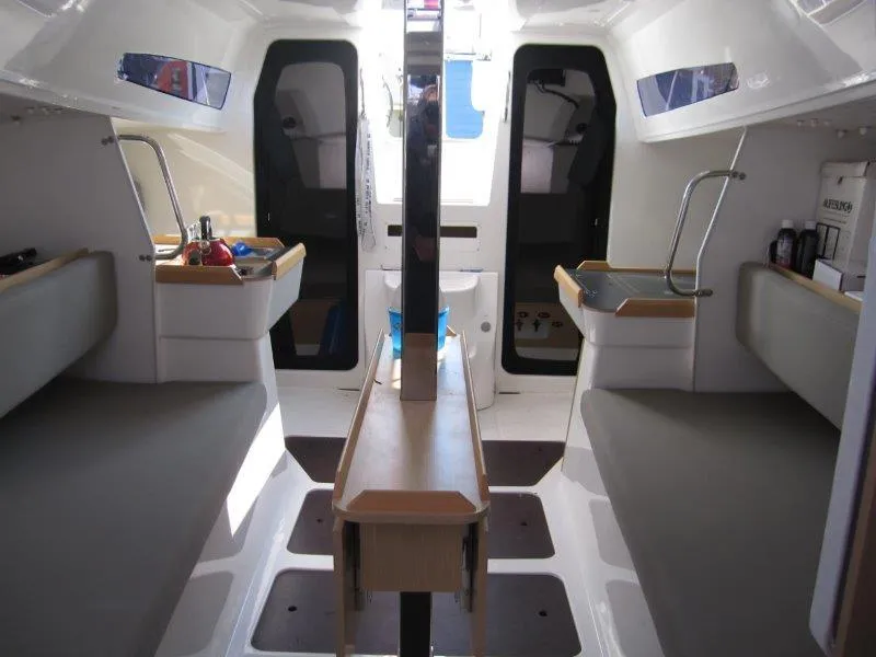 Slide: The Image of Interior of 2018 Jeanneau Sun Fast 3600 sailboat, featuring seating and storage areas. - 25