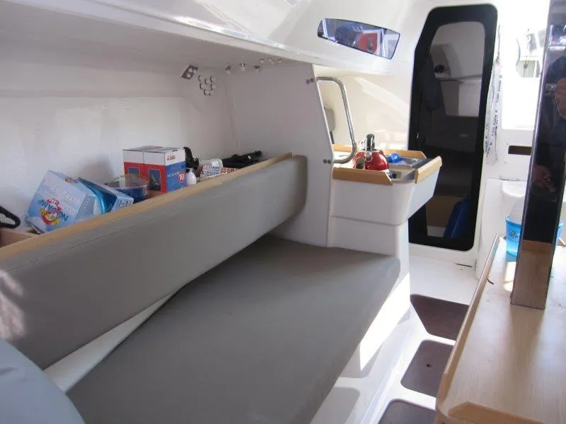 Slide: The Image of Interior of 2018 Jeanneau Sun Fast 3600 sailboat, featuring seating and compact kitchen area. - 27