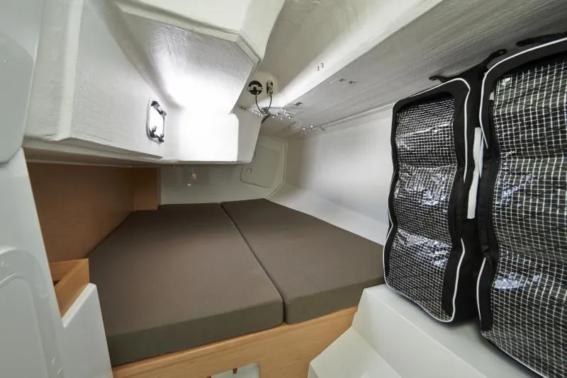 Slide: The Image of 2018 Jeanneau Sun Fast 3600 cabin interior with compact sleeping area and storage. - 4