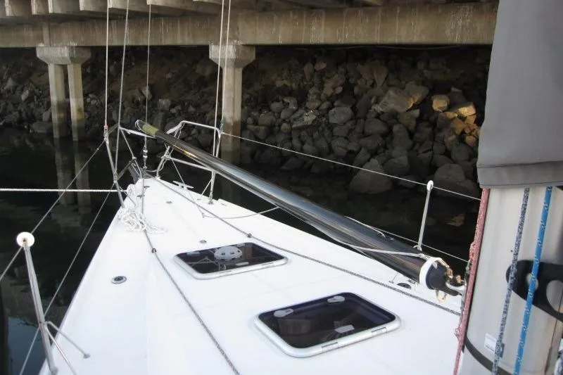 Slide: The Image of 2018 Jeanneau Sun Fast 3600 sailboat deck near rocky shoreline. - 49