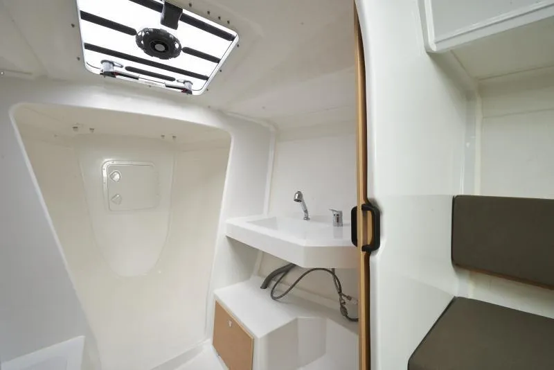 Slide: The Image of Interior of 2018 Jeanneau Sun Fast 3600 sailboat, featuring a compact bathroom with sink and seating. - 5