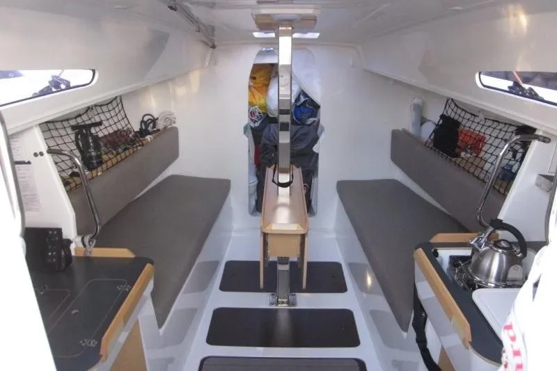 Slide: The Image of 2018 Jeanneau Sun Fast 3600 interior with seating, storage, and compact kitchen area. - 53