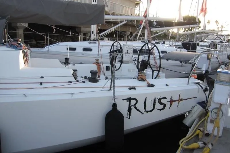 Slide: The Image of 2018 Jeanneau Sun Fast 3600 sailboat named "Rush" docked at a marina. - 66