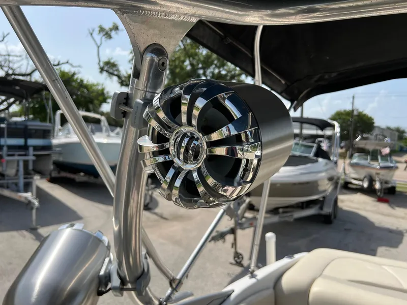Slide: The Image of Close-up of a speaker on a 2007 Chaparral 210 SSi boat, with other boats in background. - 12