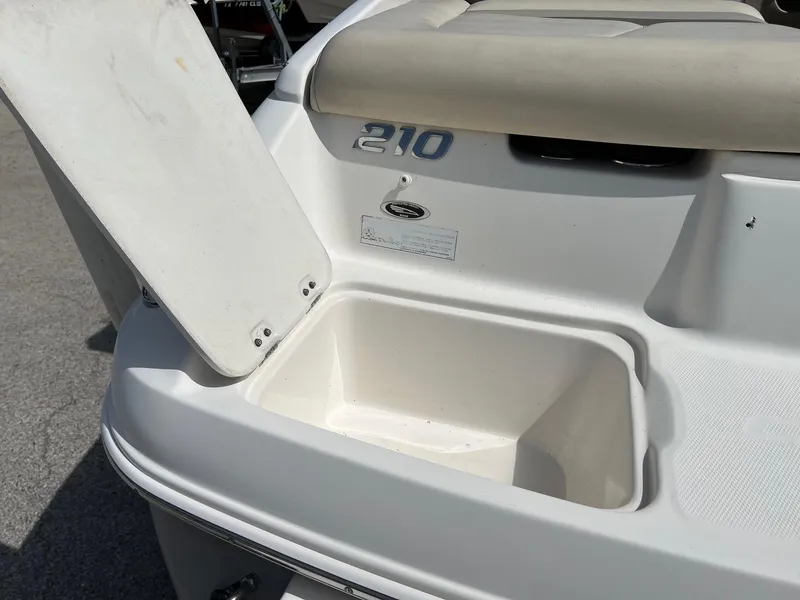 Slide: The Image of 2007 Chaparral 210 SSi boat with open storage compartment, white exterior. - 17