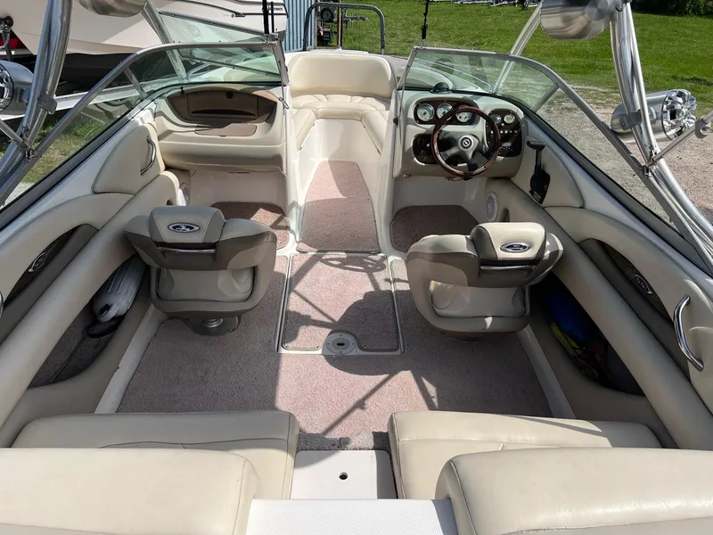 Slide: The Image of 2007 Chaparral 210 SSi boat interior with beige seating and steering wheel. - 21