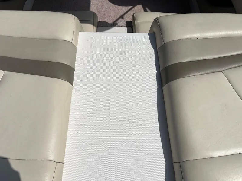 Slide: The Image of 2007 Chaparral 210 SSi boat interior with beige leather seating. - 22