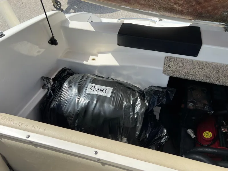 Slide: The Image of Storage compartment of a 2007 Chaparral 210 SSi boat with a labeled cover bag. - 5