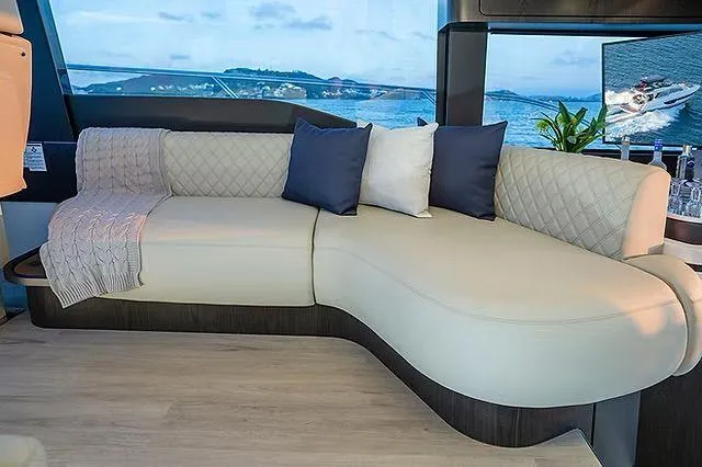Slide: The Image of Luxurious Schaefer 600 yacht interior with elegant beige sofa and scenic ocean view, 2026 model. - 12