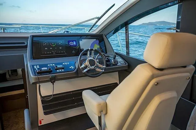 Slide: The Image of Helm of 2026 Schaefer 600 yacht with modern controls and ocean view. - 15