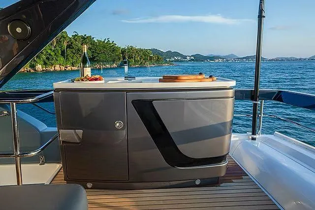 Slide: The Image of Luxurious Schaefer 600 yacht deck with ocean view, featuring a modern outdoor kitchen, 2026 model. - 25