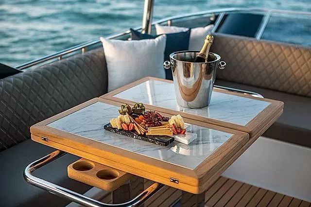 Slide: The Image of Luxurious Schaefer 600 yacht interior with champagne and charcuterie on a stylish table. - 26