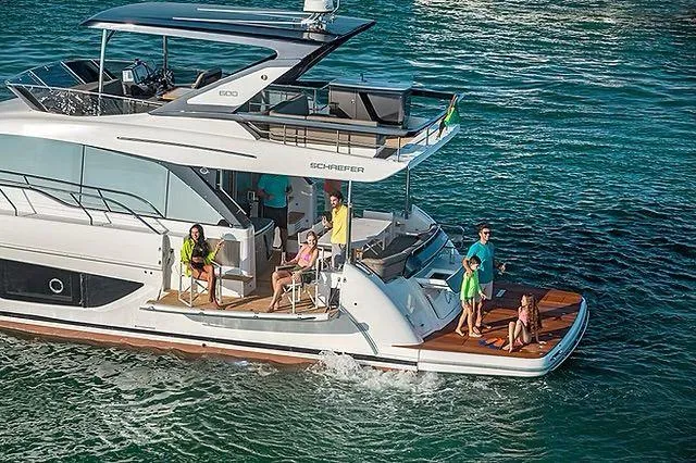 Slide: The Image of Luxurious Schaefer 600 yacht cruising with passengers, 2026 model, on clear blue waters. - 8