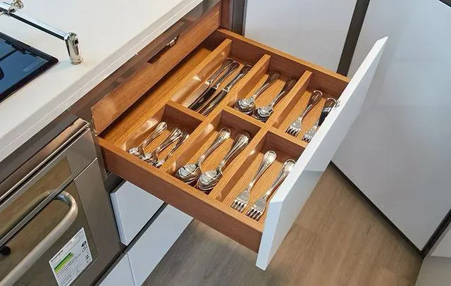 Slide: The Image of Modern kitchen drawer with organized cutlery in a Schaefer 660, 2025 model. - 10