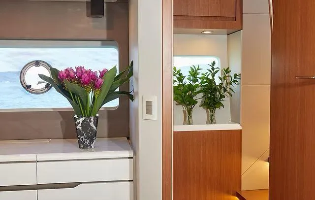Slide: The Image of Luxurious Schaefer 660 yacht interior with elegant floral decor, modern cabinetry, and ocean view. - 23