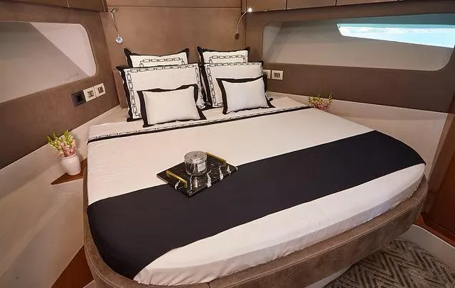 Slide: The Image of Luxurious Schaefer 660 yacht bedroom interior, 2025 model, featuring elegant bedding and modern design. - 26