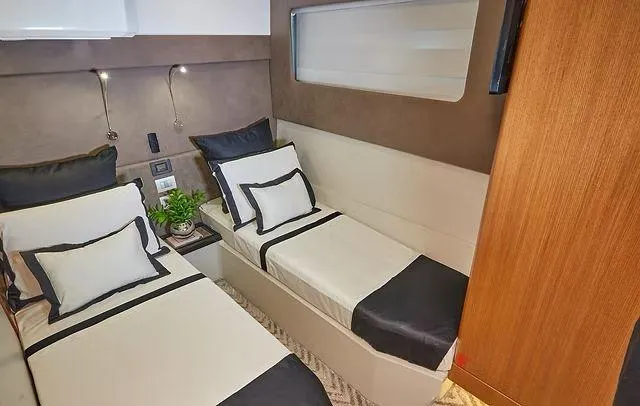 Slide: The Image of Luxurious twin cabin interior in Schaefer 660 yacht, 2025 model, with modern decor and bedding. - 28