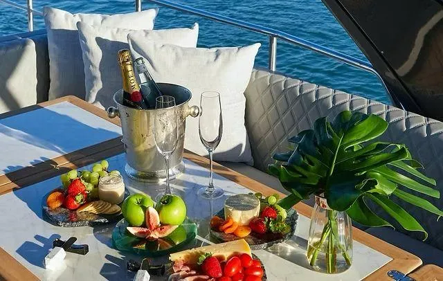 Slide: The Image of Luxurious yacht dining setup with champagne, fruits, and cheese on a Schaefer 660, 2025 model. - 33