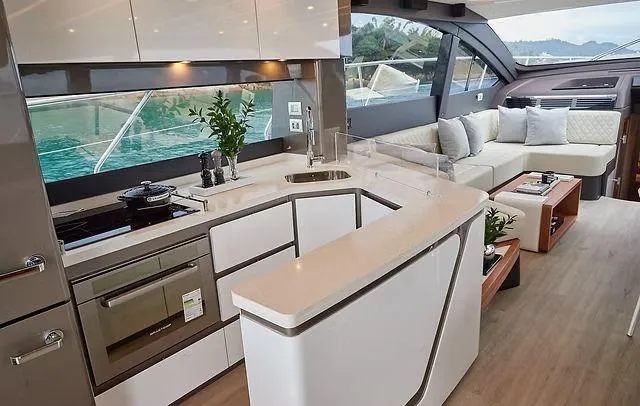 Slide: The Image of Luxurious Schaefer 660 yacht interior with modern kitchen and cozy seating area, 2025 model. - 9