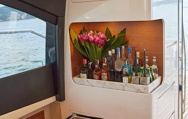 Slide: The Image of Luxurious Schaefer 660 yacht interior with bar, floral arrangement, and scenic water view. - 15
