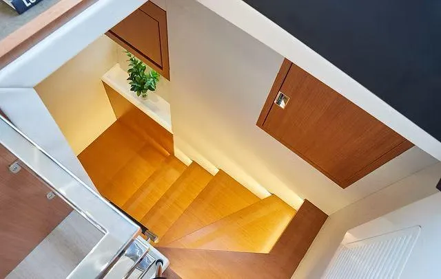 Slide: The Image of Staircase in Schaefer 660 yacht, featuring wooden steps and modern design, 2025 model. - 24