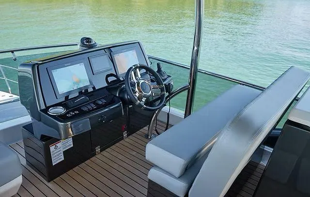 Slide: The Image of Helm of 2025 Schaefer 660 yacht with modern controls and navigation screens. - 35