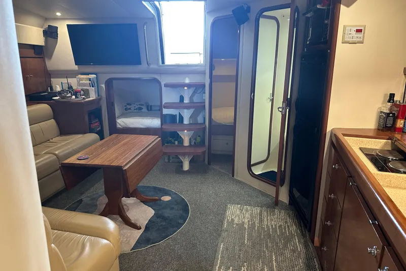 Slide: The Image of Interior of a 1998 Trojan 440 Express yacht with cozy seating and modern amenities. - 10