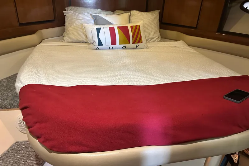 Slide: The Image of Cozy cabin interior of 1998 Trojan 440 Express yacht with bed and nautical decor. - 15