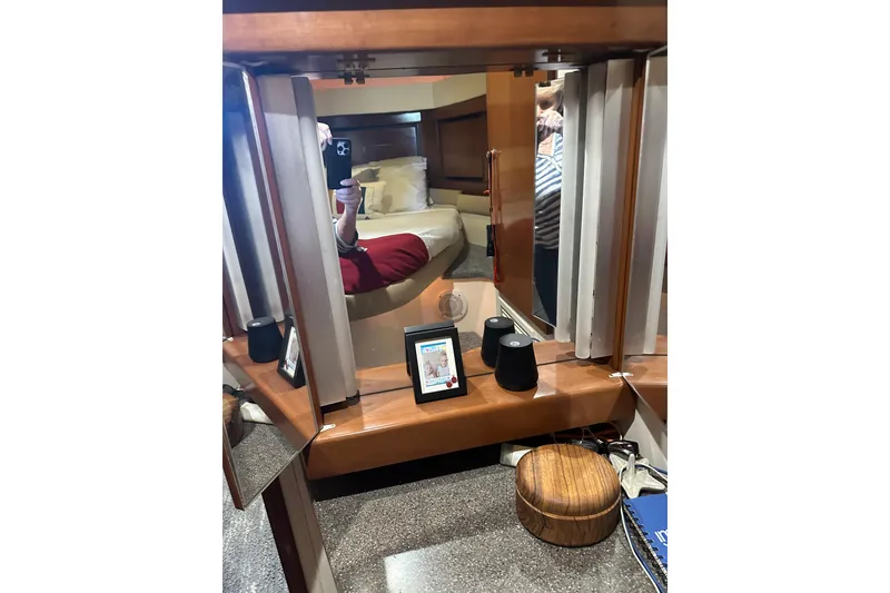 Slide: The Image of Interior of 1998 Trojan 440 Express yacht with mirror and wooden accents. - 19