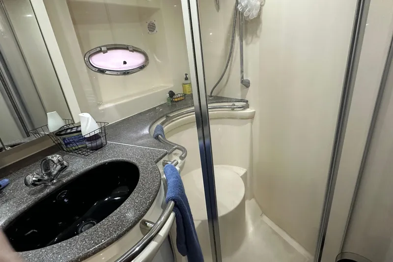 Slide: The Image of Bathroom interior of 1998 Trojan 440 Express yacht with shower and sink. - 20