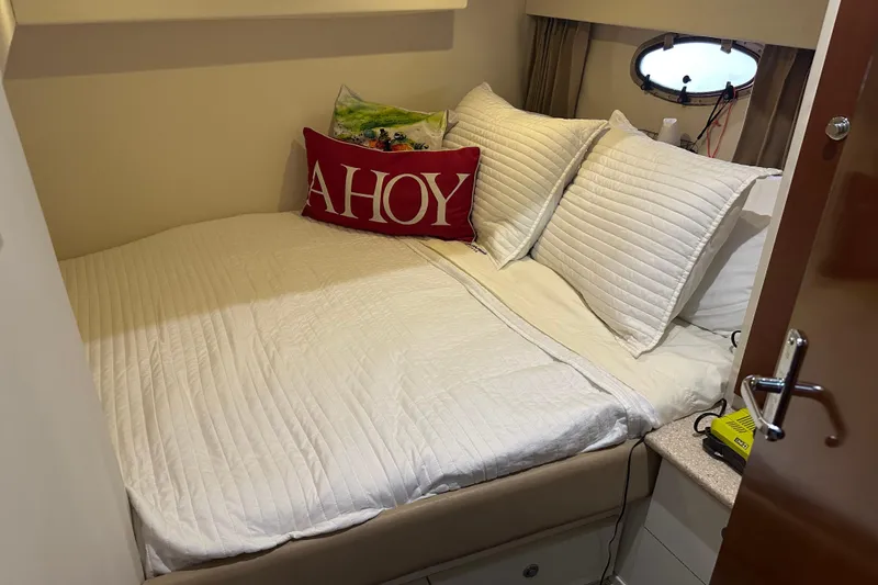 Slide: The Image of Cozy cabin bedroom in 1998 Trojan 440 Express yacht with nautical decor. - 22