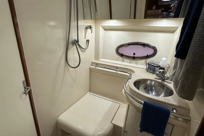 Slide: The Image of Bathroom interior of 1998 Trojan 440 Express yacht with shower and sink. - 24