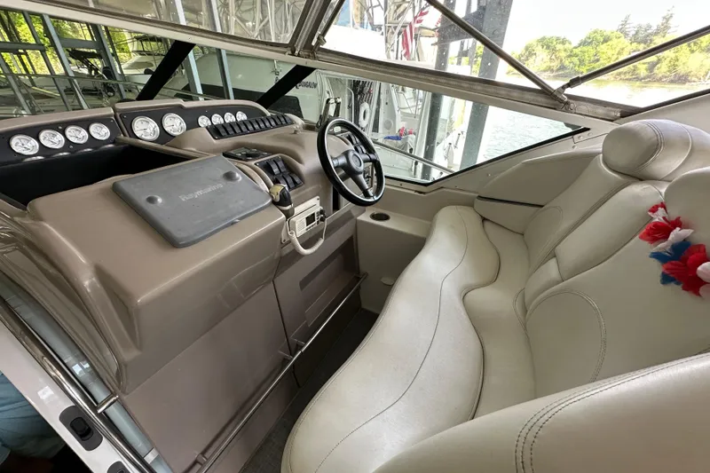 Slide: The Image of Interior of a 1998 Trojan 440 Express boat with steering wheel and dashboard. - 26