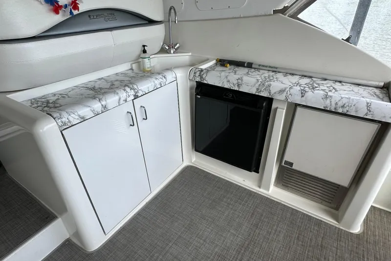 Slide: The Image of Interior of 1998 Trojan 440 Express yacht with marble countertops and compact appliances. - 28