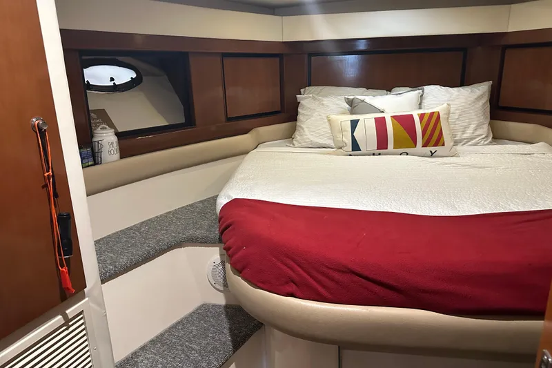 Slide: The Image of Cozy cabin interior of 1998 Trojan 440 Express yacht with plush bedding and nautical decor. - 3