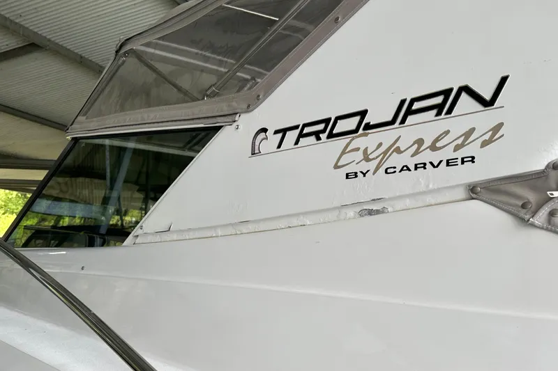 Slide: The Image of 1998 Trojan 440 Express boat side view with logo and window detail. - 31