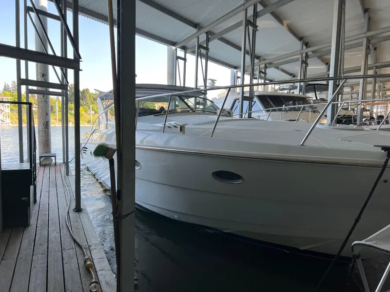 Slide: The Image of 1998 Trojan 440 Express yacht docked in a covered marina. - 34