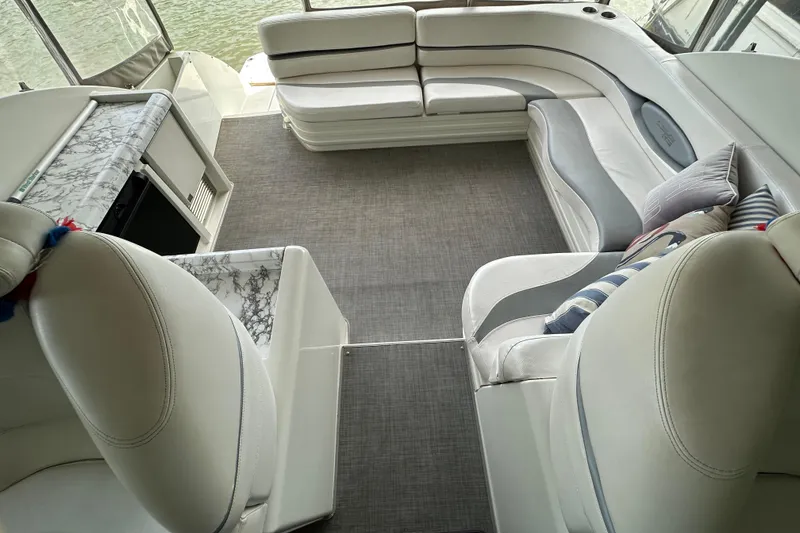 Slide: The Image of Luxurious interior of a 1998 Trojan 440 Express yacht with elegant seating and marble accents. - 4