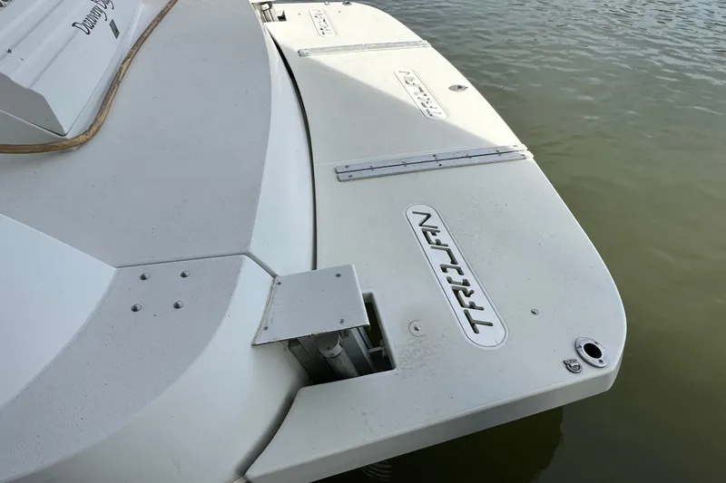 Slide: The Image of 1998 Trojan 440 Express boat stern on calm water. - 5