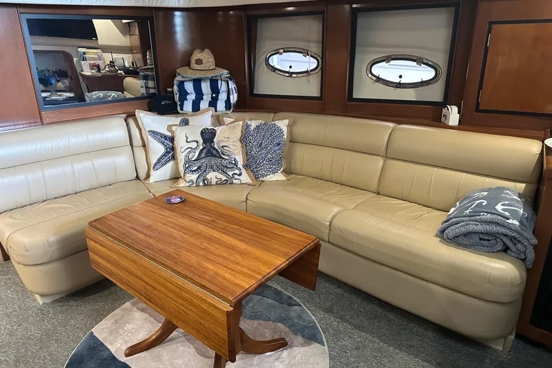 Slide: The Image of Luxurious interior of 1998 Trojan 440 Express yacht with beige leather seating and nautical decor. - 9