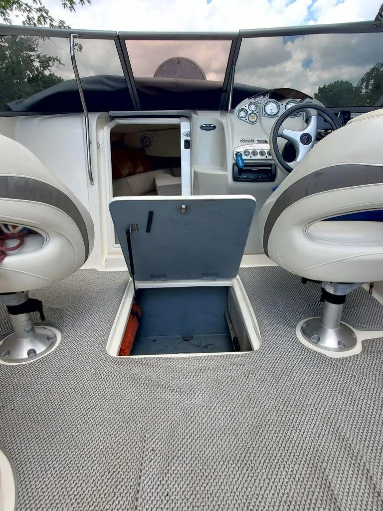 Slide: The Image of Interior of a 2006 Maxum SC3 boat with cushions and speakers. - 6