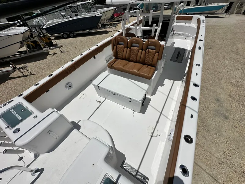 Slide: The Image of 2023 Twin Vee 340 GFX CC boat with brown seating and spacious deck. - 10