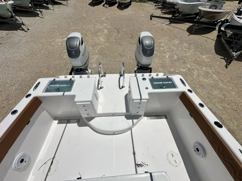 Slide: The Image of 2023 Twin Vee 340 GFX CC boat with dual outboard engines, viewed from the rear deck. - 11