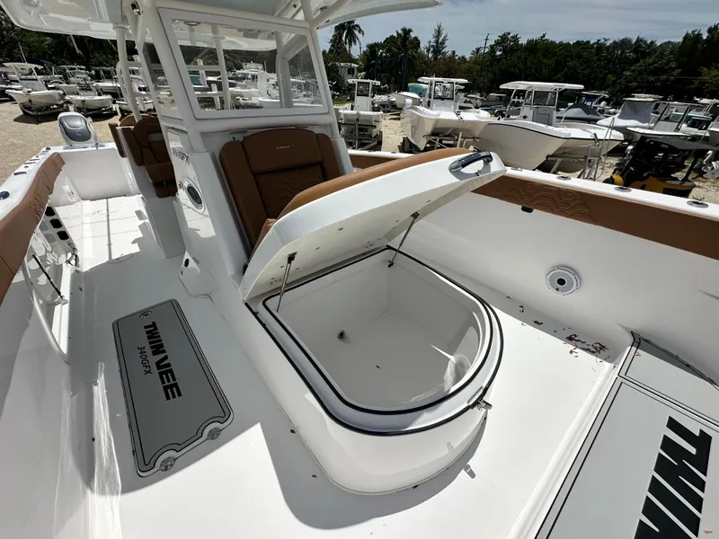 Slide: The Image of 2023 Twin Vee 340 GFX CC boat interior with open storage compartment. - 16