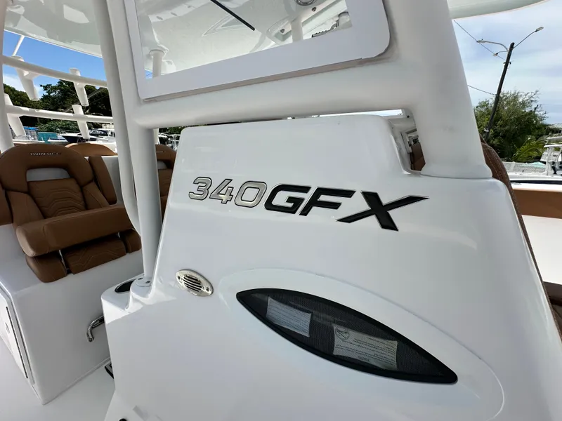 Slide: The Image of 2023 Twin Vee 340 GFX CC boat interior with logo and seating detail. - 17