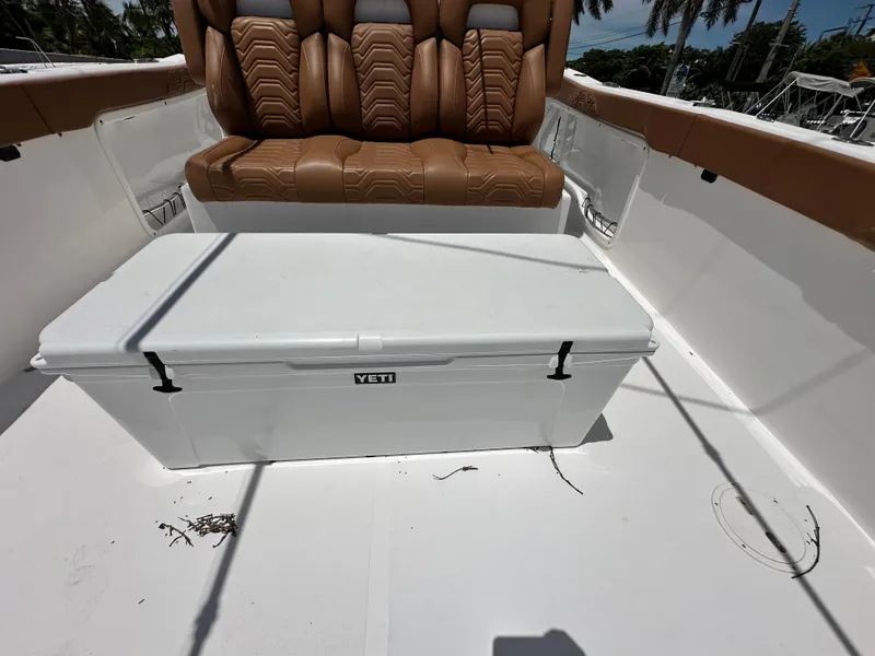 Slide: The Image of 2023 Twin Vee 340 GFX CC boat interior with brown seating and Yeti cooler. - 20