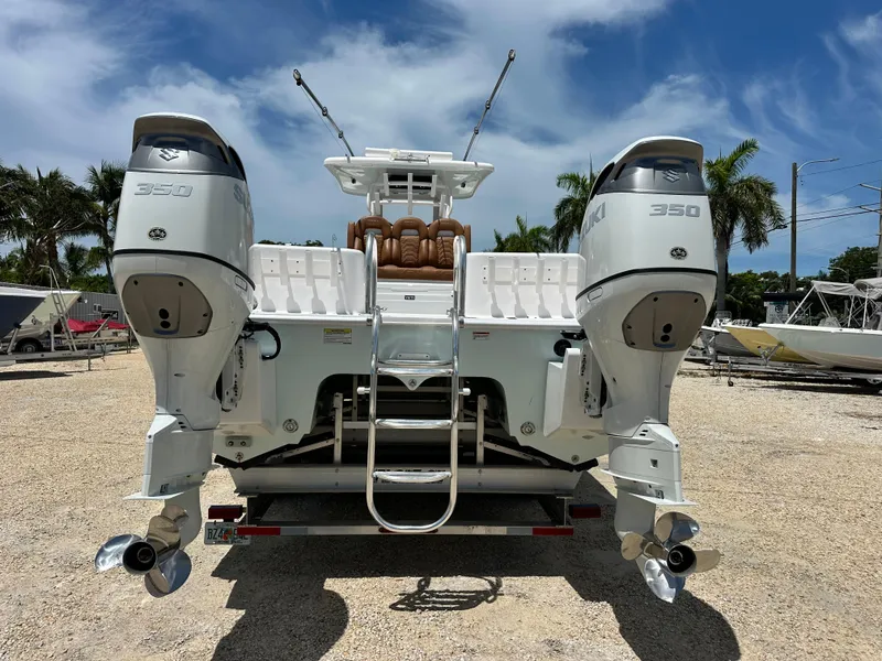 Slide: The Image of 2023 Twin Vee 340 GFX CC boat with dual Suzuki 350 engines, parked outdoors. - 4