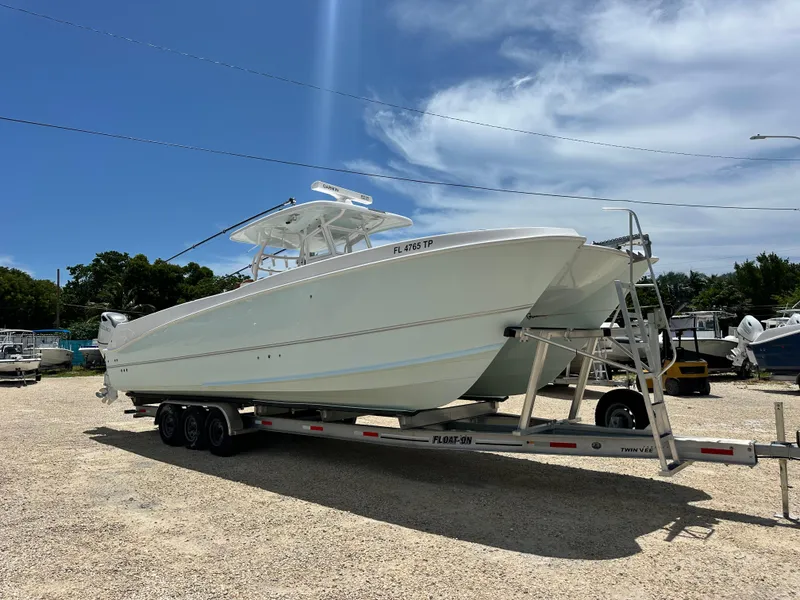Slide: The Image of 2023 Twin Vee 340 GFX CC boat on trailer under clear blue sky. - 6
